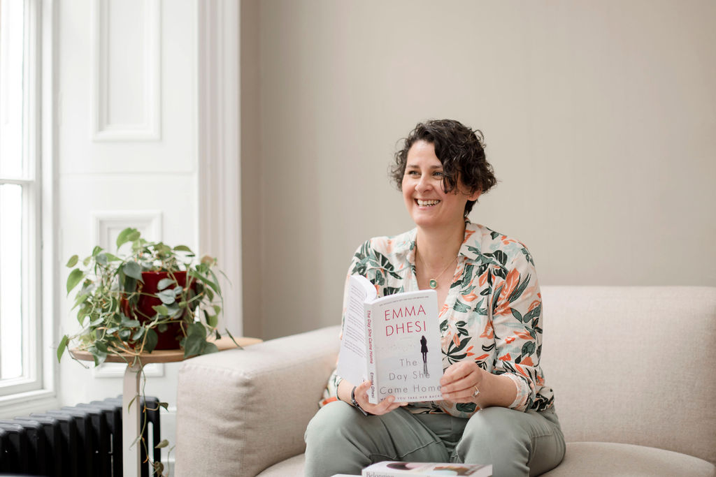 smiling woman with a book in her hand