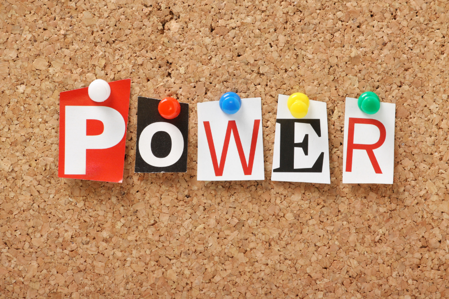 A corkboard with the letters making up 'power' pinned onto it. 