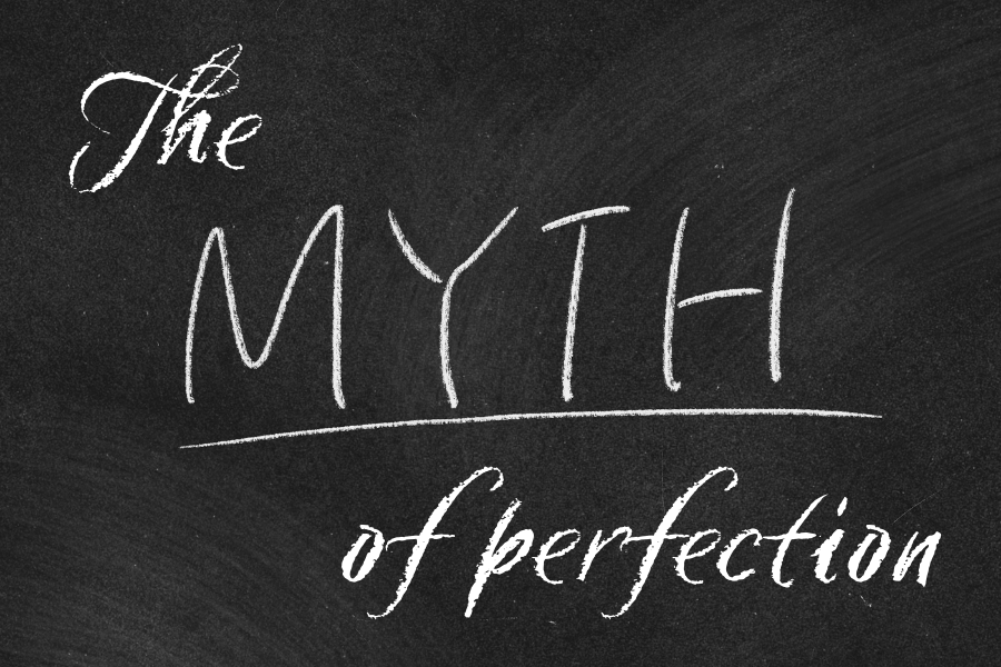 A black background with 'the myth of perfection' written in white chalk letters