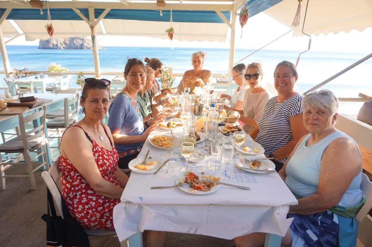 Retreat group having dinner by the sea